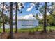 Scenic view of a serene lake framed by trees, offering a peaceful and natural setting, perfect for lakeside living at 5365 Bowman Dr, Winter Garden, FL 34787