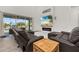Bright living room with modern fireplace, beach view on TV and sliding doors to outdoor pool at 5365 Bowman Dr, Winter Garden, FL 34787