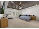 Spacious bedroom featuring a decorative ceiling, plush carpet and lots of natural light at 5365 Bowman Dr, Winter Garden, FL 34787