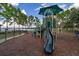 A green playground with a slide and other play structures, surrounded by trees and providing a fun space for children at 5365 Bowman Dr, Winter Garden, FL 34787