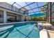 Large screened pool with poolside seating and a view of the beautiful backyard at 5365 Bowman Dr, Winter Garden, FL 34787