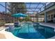Picturesque screened-in pool area with an in-pool bar and luxurious lounge seating at 5365 Bowman Dr, Winter Garden, FL 34787