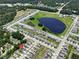 Aerial view of neighborhood homes, pond, and streets at 6780 Coral Berry Dr, Mount Dora, FL 32757