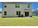 Exterior view of a house with a well-maintained backyard, including a covered patio area at 6780 Coral Berry Dr, Mount Dora, FL 32757