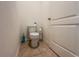 Toilet room featuring a standard toilet, light beige tile floor, and white walls at 6780 Coral Berry Dr, Mount Dora, FL 32757
