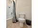 Cozy bathroom with a shower-tub combo featuring white tile and a standard toilet at 6780 Coral Berry Dr, Mount Dora, FL 32757