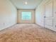 Bright bedroom with carpeted floors and a window providing natural light at 6780 Coral Berry Dr, Mount Dora, FL 32757