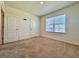 Bedroom with neutral carpet, a window with blinds, and two standard closets at 6780 Coral Berry Dr, Mount Dora, FL 32757