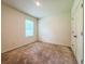 Clean bedroom featuring neutral carpet, a window with blinds, and a standard closet at 6780 Coral Berry Dr, Mount Dora, FL 32757