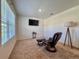 Cozy bedroom with plush carpet, a reading chair and a floor lamp at 6780 Coral Berry Dr, Mount Dora, FL 32757