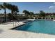 Inviting community pool with lounge chairs, perfect for relaxation and recreation at 6780 Coral Berry Dr, Mount Dora, FL 32757