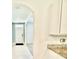 Bright entryway featuring an archway, white walls, and neutral-colored tile flooring at 6780 Coral Berry Dr, Mount Dora, FL 32757