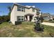 Attractive two-story house with a well-manicured front lawn, lush landscaping, and gray window shutters at 6780 Coral Berry Dr, Mount Dora, FL 32757