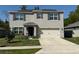 Inviting two-story home featuring a covered entry and a spacious driveway leading to the garage at 6780 Coral Berry Dr, Mount Dora, FL 32757