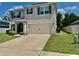 Charming two-story home with a well-maintained lawn and attached two-car garage at 6780 Coral Berry Dr, Mount Dora, FL 32757