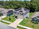 Exterior view of a two-story home with solar panels, attached garage, and landscaped front yard at 6780 Coral Berry Dr, Mount Dora, FL 32757