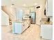 Bright kitchen with island, stainless steel appliances, tile backsplash, and ample cabinet space at 6780 Coral Berry Dr, Mount Dora, FL 32757