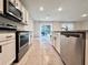 Bright kitchen with stainless steel appliances, granite countertops, and an eat-in dining space at 6780 Coral Berry Dr, Mount Dora, FL 32757
