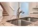 Close-up of a kitchen featuring granite countertop, stainless steel sink and faucet at 6780 Coral Berry Dr, Mount Dora, FL 32757