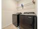 Laundry room featuring a modern, front-load washer and dryer set, with a wire shelf above at 6780 Coral Berry Dr, Mount Dora, FL 32757