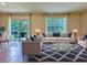 A stylishly decorated living room filled with natural light and views of the outdoors at 6780 Coral Berry Dr, Mount Dora, FL 32757