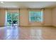 Bright living room with tile flooring, a sliding glass door, and a large window at 6780 Coral Berry Dr, Mount Dora, FL 32757