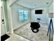 Cozy living room with large window and chair, offering a relaxing atmosphere and plenty of natural light at 6780 Coral Berry Dr, Mount Dora, FL 32757