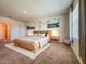 Spacious primary bedroom features modern decor, carpet, a large window and an ensuite bathroom at 6780 Coral Berry Dr, Mount Dora, FL 32757