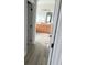 Hallway view into bathroom with double vanity and wooden cabinets at 7561 Colbury Ave, Windermere, FL 34786