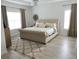 Bedroom featuring a neutral color palette, tufted headboard, and hardwood floors at 7561 Colbury Ave, Windermere, FL 34786