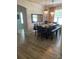 Bright dining area with chandelier lighting, hardwood floors, and a large mirror at 7561 Colbury Ave, Windermere, FL 34786