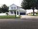 Lovely home with a well-kept lawn, dark shutters, and an attached two-car garage at 7561 Colbury Ave, Windermere, FL 34786