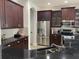 Kitchen with stainless steel appliances, dark cabinetry, and tile backsplash at 7561 Colbury Ave, Windermere, FL 34786