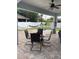 Covered patio with stone flooring, dining table, and yard views at 7561 Colbury Ave, Windermere, FL 34786
