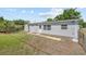 Home's backyard showing the building's exterior, lawn and additional outbuilding at 7701 Cassino Ave, Orlando, FL 32819