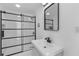 Modern bathroom features a black framed glass shower and sleek vanity at 7701 Cassino Ave, Orlando, FL 32819