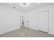 Bedroom with tile floor, closet, and bathroom access at 7701 Cassino Ave, Orlando, FL 32819