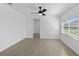 Well-lit bedroom with wood-look flooring and a large window at 7701 Cassino Ave, Orlando, FL 32819