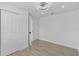 Bedroom with wood-look floors, a modern ceiling fan, and double door closet at 7701 Cassino Ave, Orlando, FL 32819