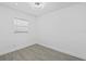 Clean bedroom featuring wood-look floors and a large window at 7701 Cassino Ave, Orlando, FL 32819