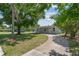 A charming single-story home with a well-manicured lawn and a winding driveway leading to the house at 7701 Cassino Ave, Orlando, FL 32819