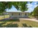 Charming single-story home features a covered front porch, white door and windows, and a well-maintained lawn at 7701 Cassino Ave, Orlando, FL 32819