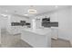 Modern kitchen with sleek white cabinetry, a waterfall island, and stainless steel appliances, perfect for cooking at 7701 Cassino Ave, Orlando, FL 32819