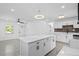 Open concept kitchen features stainless steel appliances, a kitchen island and modern pendant lighting at 7701 Cassino Ave, Orlando, FL 32819