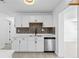 Updated kitchen features white cabinets, stainless steel appliances, and modern countertops at 7701 Cassino Ave, Orlando, FL 32819
