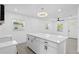 Bright kitchen with a marble island, stainless appliances, modern lighting, and an open-concept design at 7701 Cassino Ave, Orlando, FL 32819