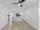 Bright living space showcases wood look floors and a neutral color scheme with open kitchen view at 7701 Cassino Ave, Orlando, FL 32819