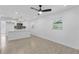 Bright living space with modern light fixtures, white walls, wood look floors, and large windows at 7701 Cassino Ave, Orlando, FL 32819