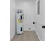Compact utility room with a modern water heater and clean design at 7701 Cassino Ave, Orlando, FL 32819