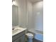 Bathroom featuring a combination tub and shower, a vanity with sink and gray cabinet at 7980 Syracuse Dr, Clermont, FL 34714